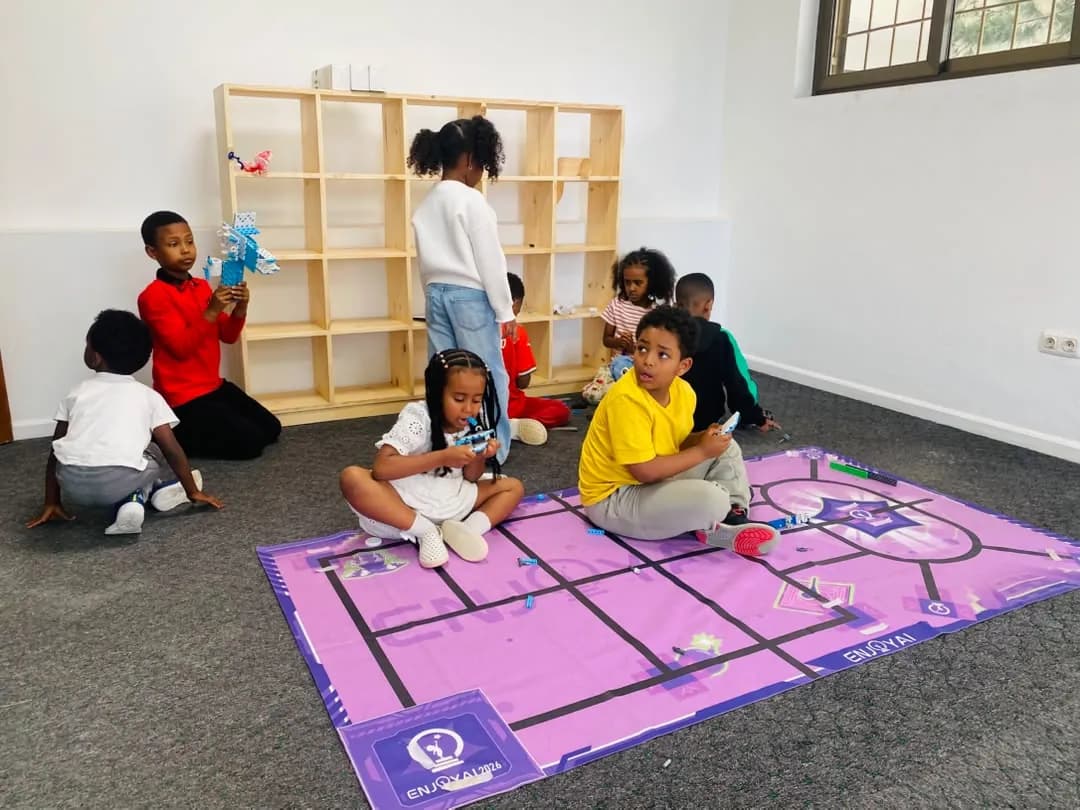 Children gathered around a purple robot coding mat with wooden shelves behind them