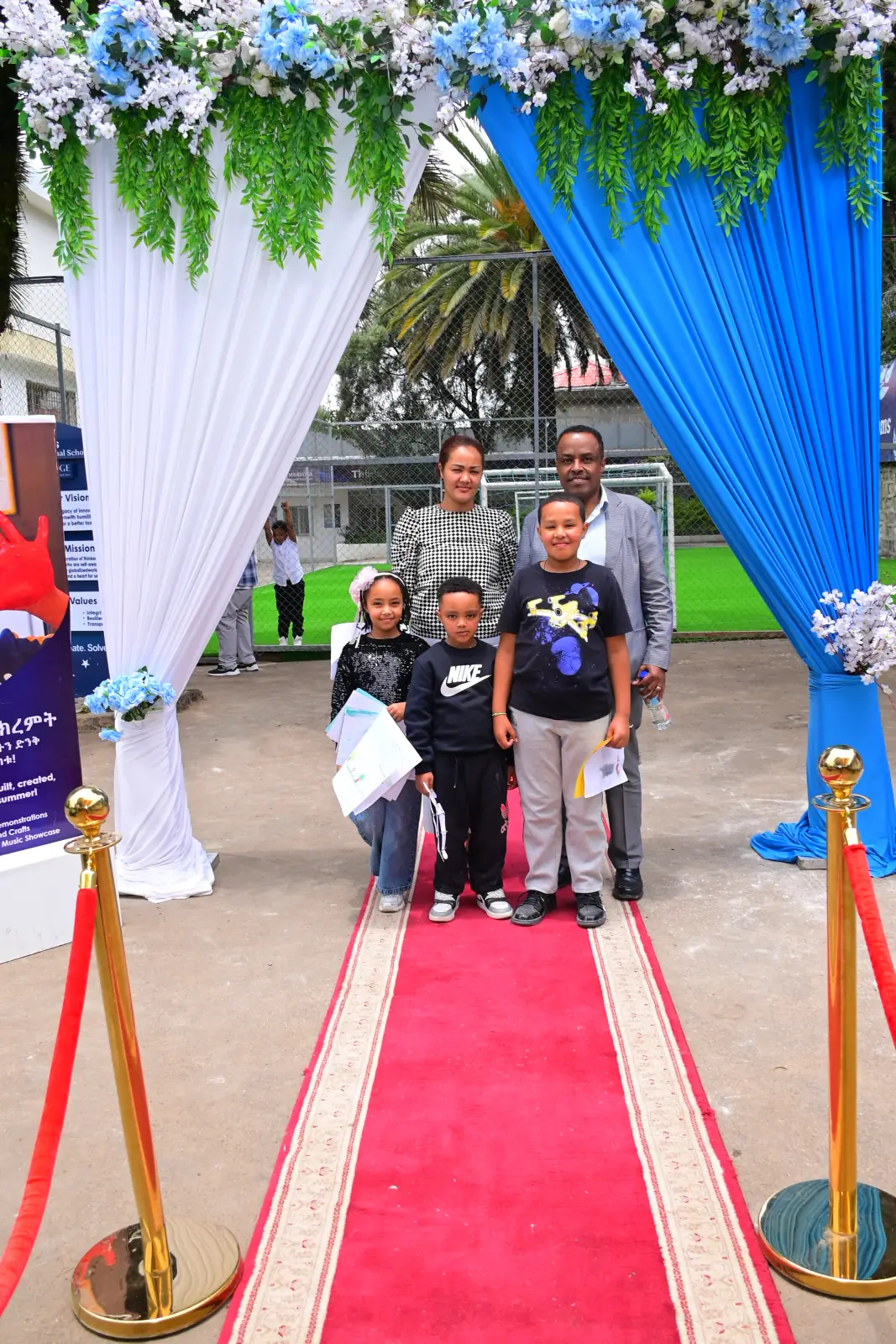 Campers walking the red carpet holding their summer camp Certificates of Participation